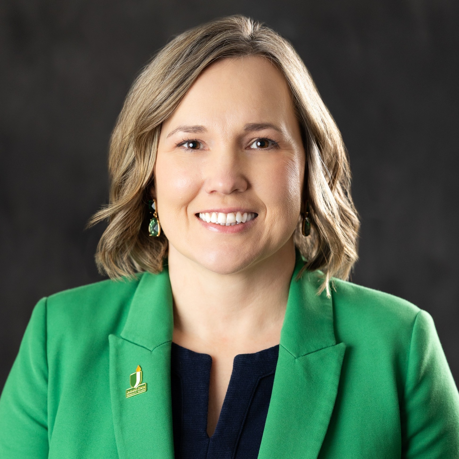 Portrait of Carol Rothstein, President of JSCC, smiling and facing the camera in a professional setting.