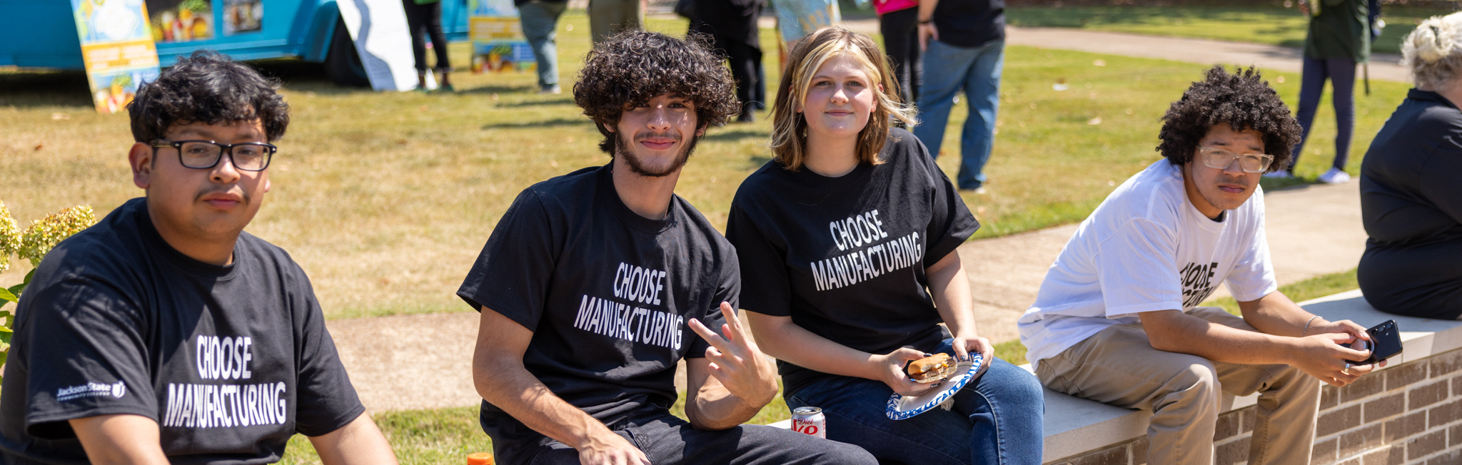 Group of JSCC students sitting in the quad wearing 
