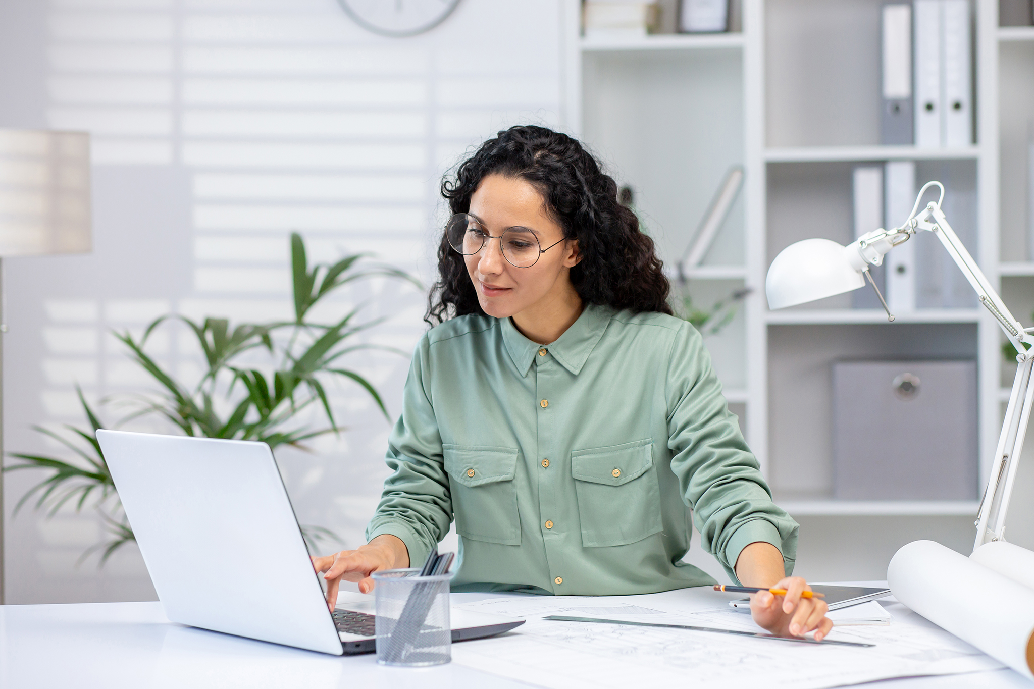 Professional woman working on a laptop in an office