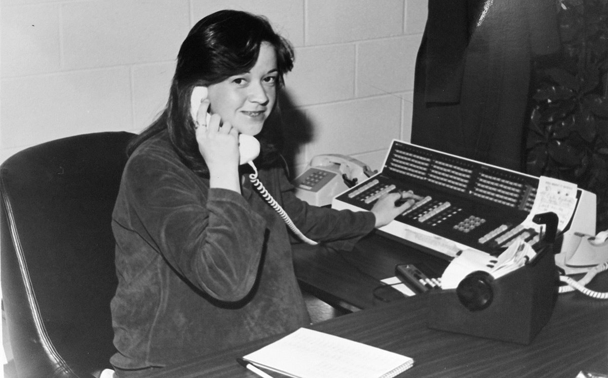 Archived Photo of Margie Lester in the 1970s answering the phone as a receptionist.