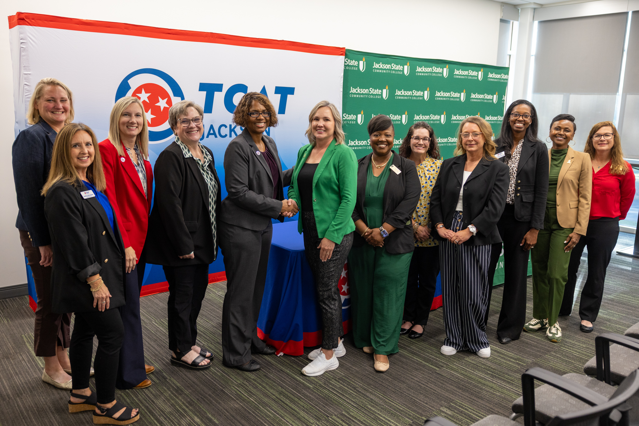 TCAT Jackson and JSCC Officials pose for a group handshake photo at the articluation agreement signing to allow TCAT students to transfer credit toward JSCC's Health Sciences Degree.